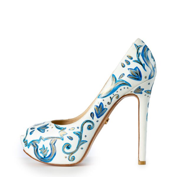 Side view of hand-painted design on white high-heel